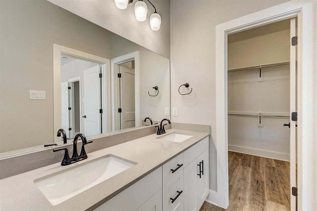 a bathroom with two sinks and a large mirror