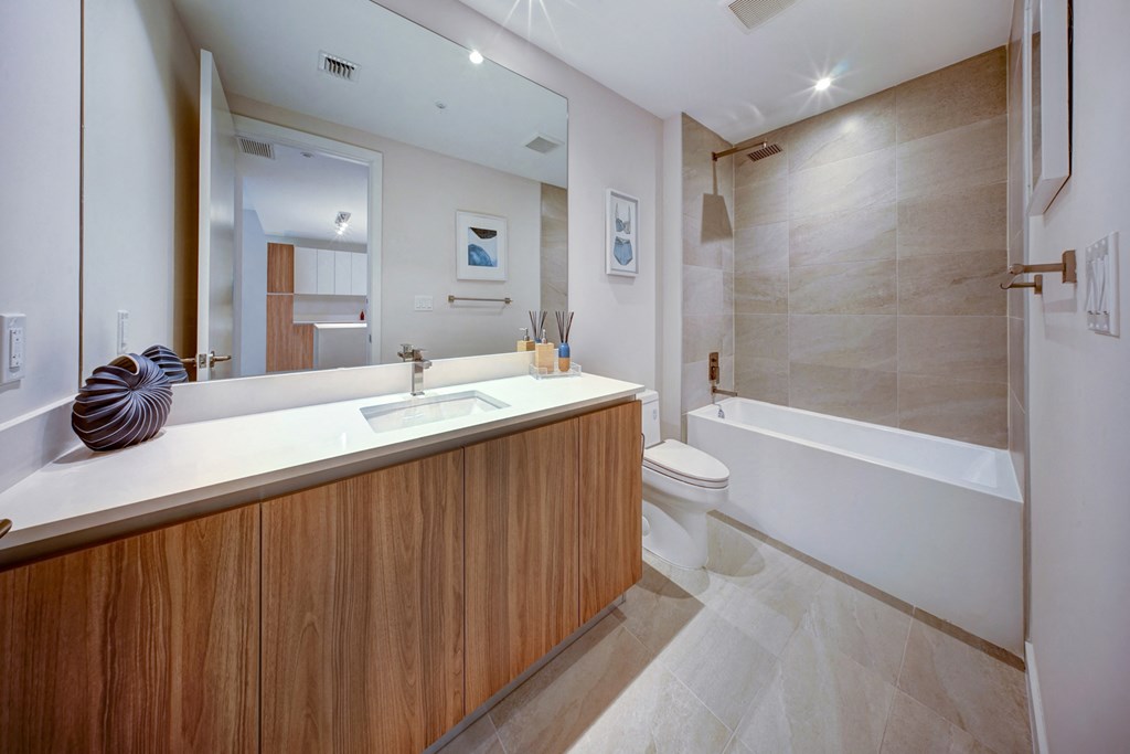 a bathroom with a sink and a shower and a toilet