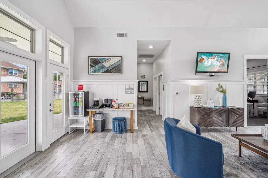 Apartment clubhouse with coffee bar, seating, and television.