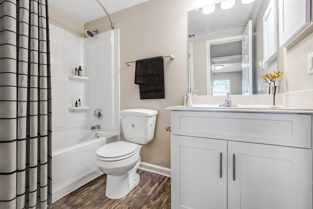 Modern Apartments in Houston, TX for Rent- Artisan West-  A white toilet sits in a bathroom next to a white sink.