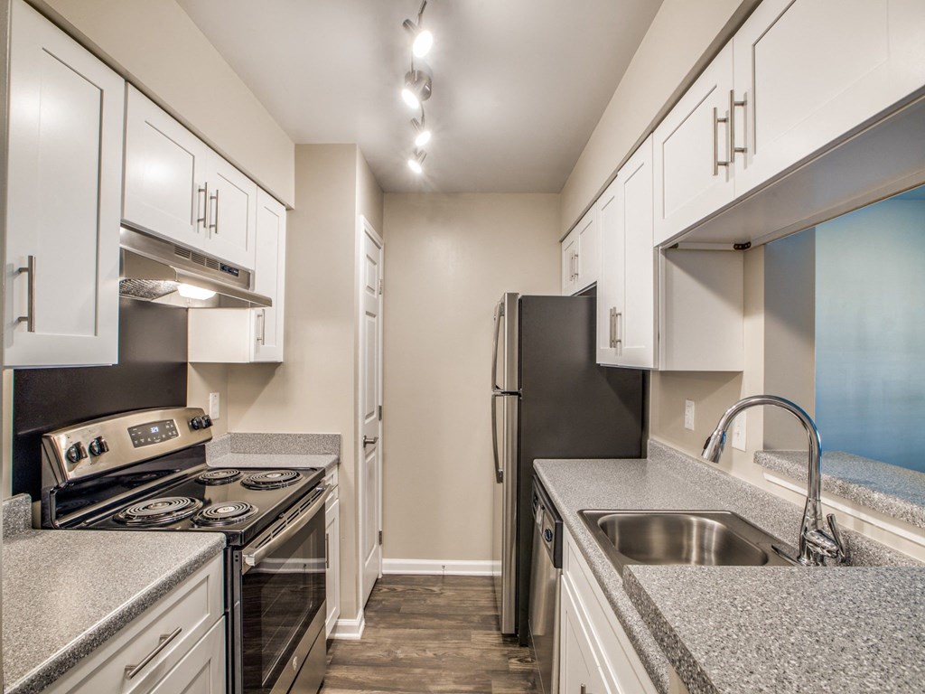 a kitchen with granite counter tops and stainless steel appliances