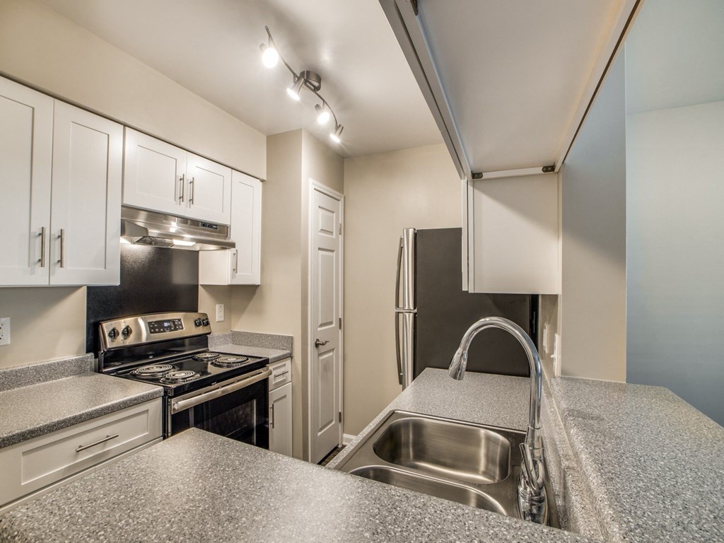 a kitchen with stainless steel appliances and granite counter tops