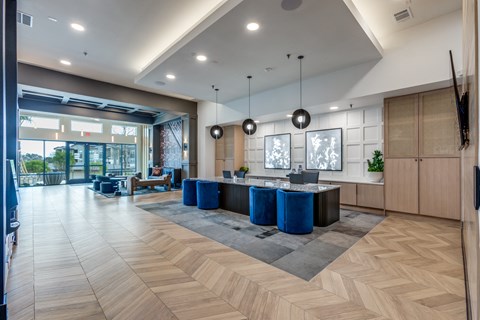A spacious room with a reception desk and a large window.