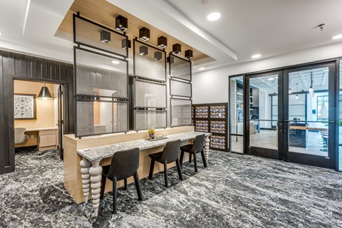 A modern dining area with a long table and chairs.