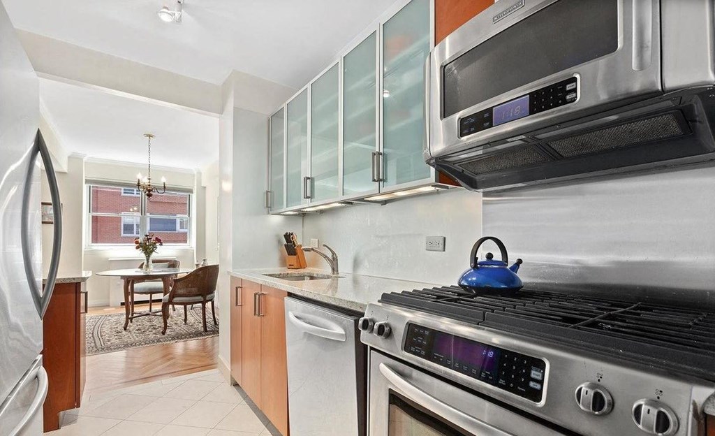 a kitchen with a stove top oven next to a sink