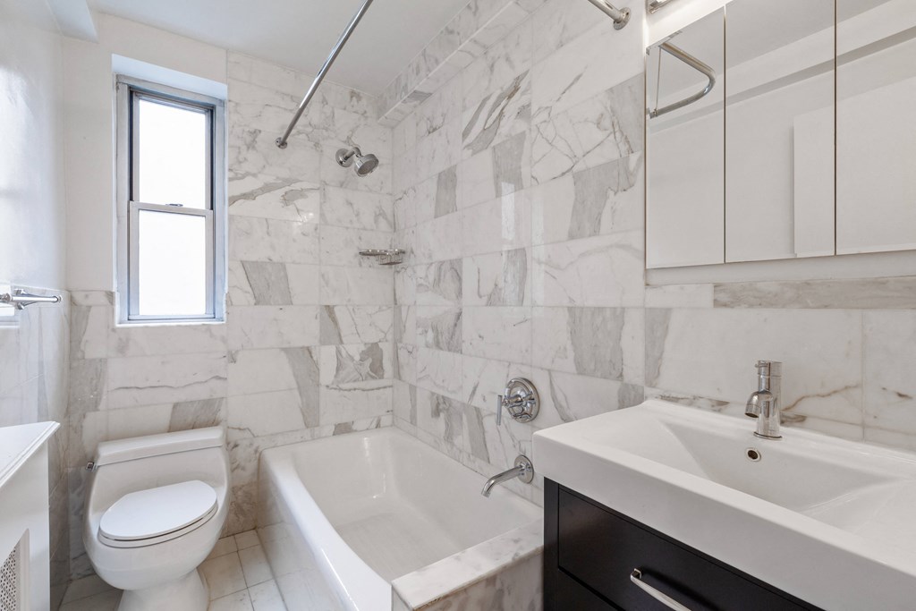 a bathroom with a toilet sink and bathtub