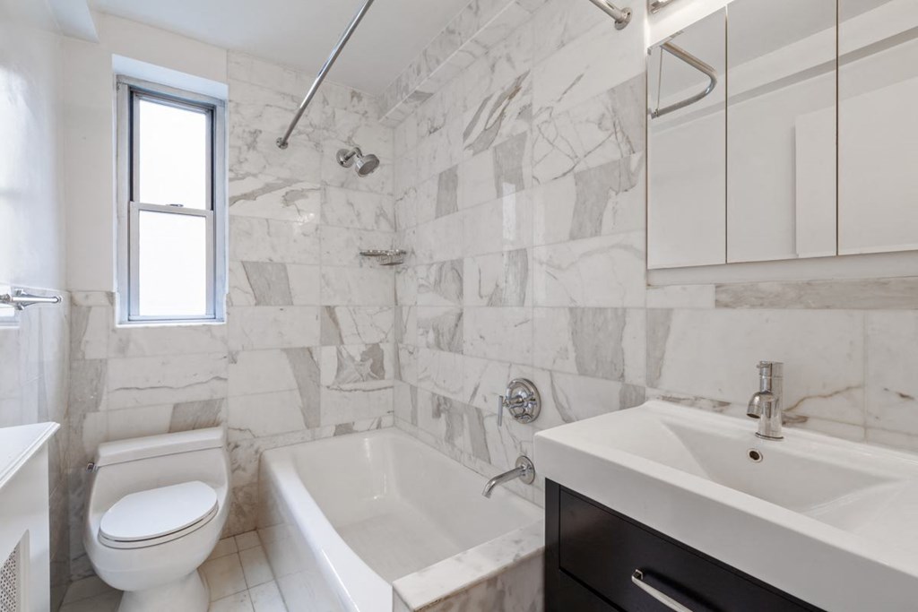 a bathroom with a toilet sink and bathtub