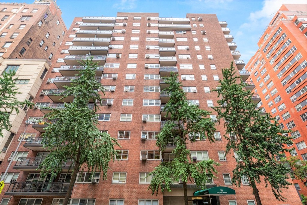 a red brick building with trees in front of it