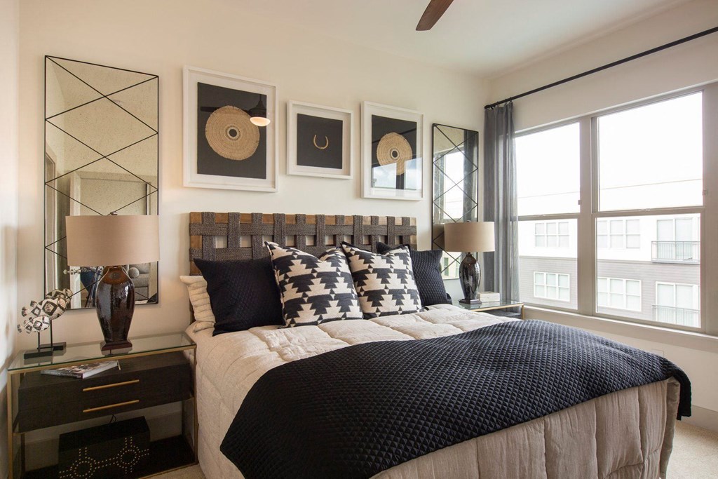 Apartments in Atlanta, GA for rent - Arabelle Perimeter - bedroom with a bed and pictures on the wall