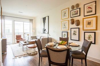 a living room and dining room with a table and chairs
