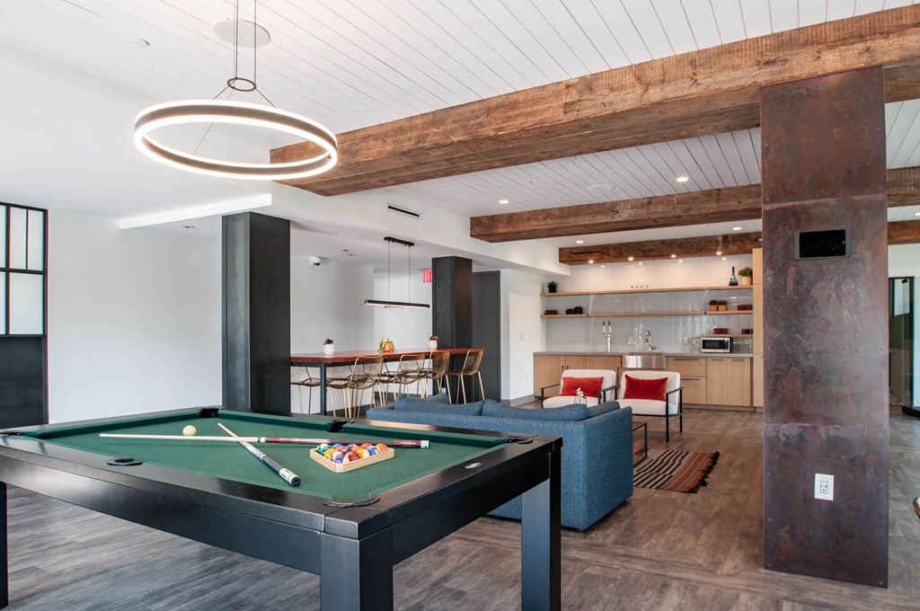 a game room with a pool table and a bar