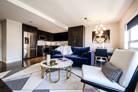 A modern living room with a blue sofa and a coffee table.