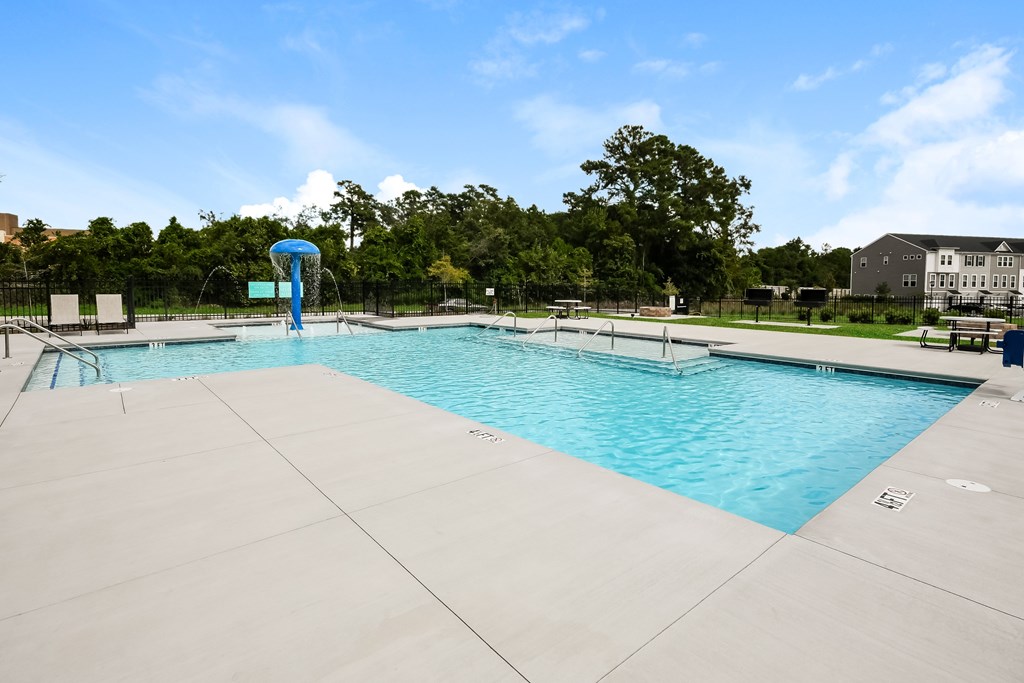 A large swimming pool with a slide in the middle.