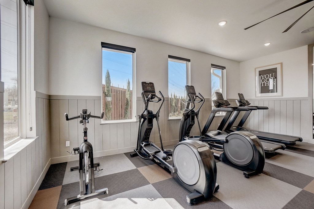 the gym has plenty of exercise equipment and views of the city