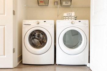 Apartments In Sandy Springs, GA for Rent – Arabelle Perimeter –two washing machines sitting next to each other in a laundry room