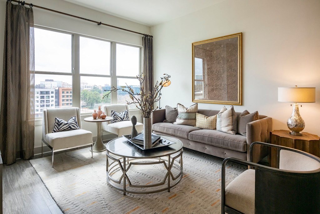 Pet-Friendly Apartments in Atlanta, GA - Arabelle Perimeter - living room with a large window and a couch