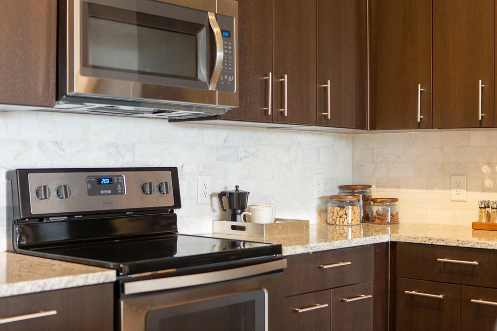 Pet-Friendly Apartments in Atlanta, GA - Arabelle Perimeter - kitchen with stainless steel appliances and granite counter tops