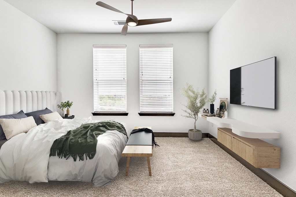 a bedroom with a large bed and a ceiling fan