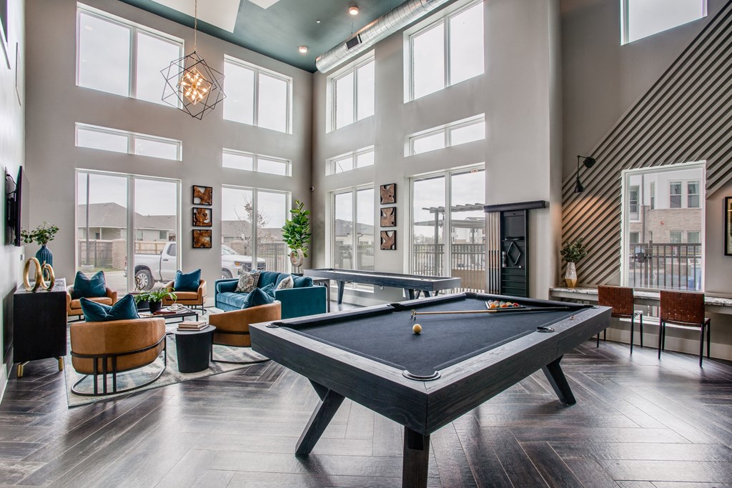 a pool table in the clubhouse at the bradley braddock road station apartments