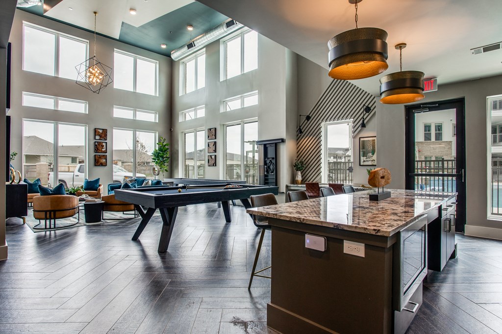 an open floor plan with a pool table and lounge area