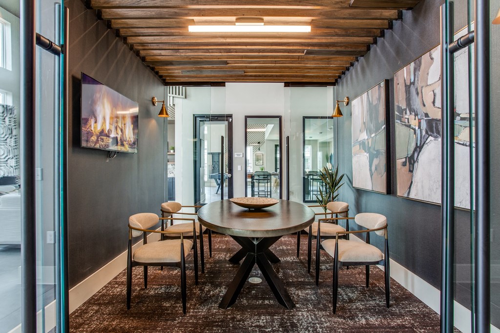 a dining area with a wooden table and chairs