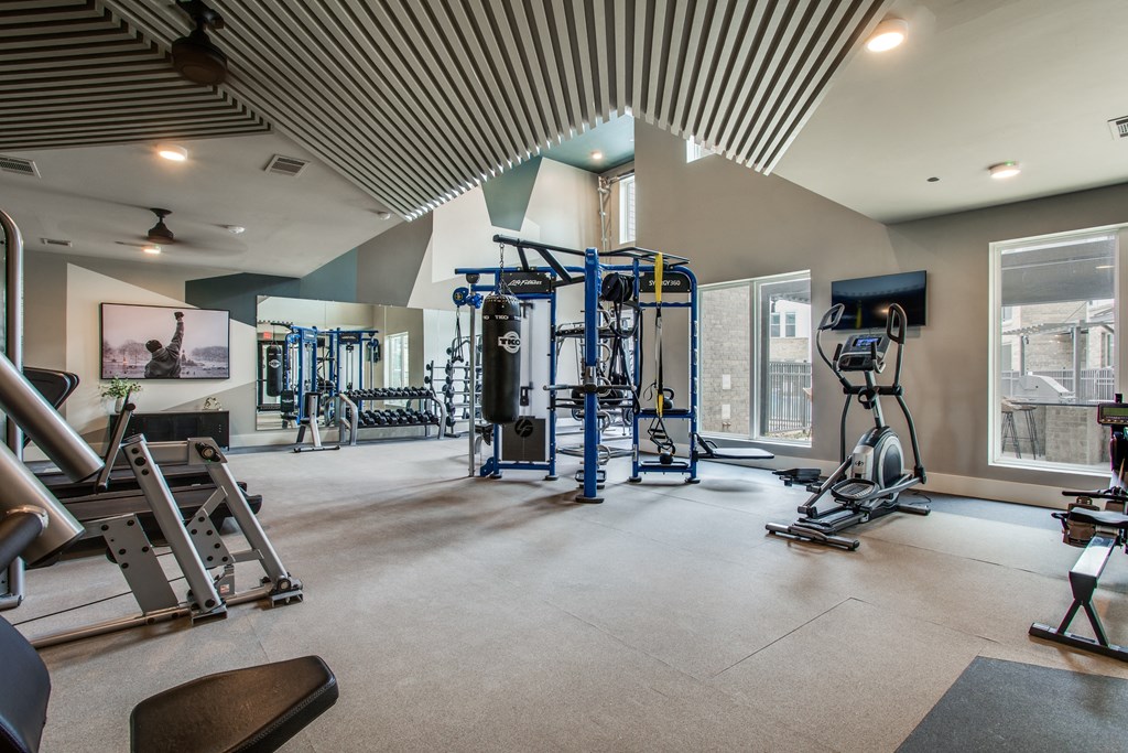 a fitness center with weights and cardio equipment at trillium apartments in fairfax, va
