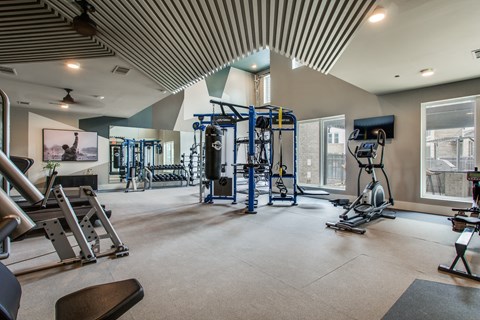 a fitness center with weights and cardio equipment at trillium apartments in fairfax, va