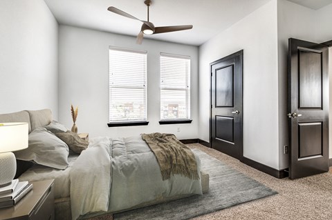 a bedroom with a large bed and a ceiling fan
