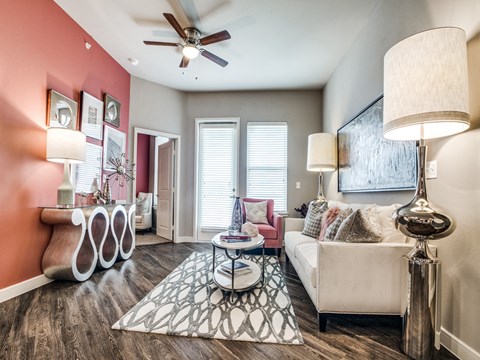 a living room with a couch and a ceiling fan