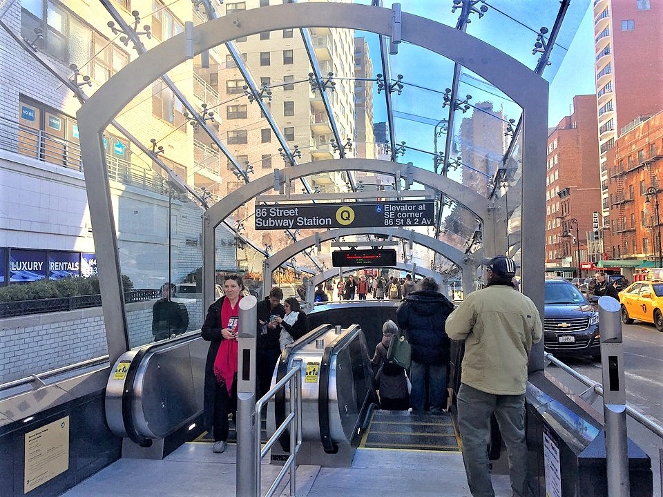 a group of people standing on a subway train