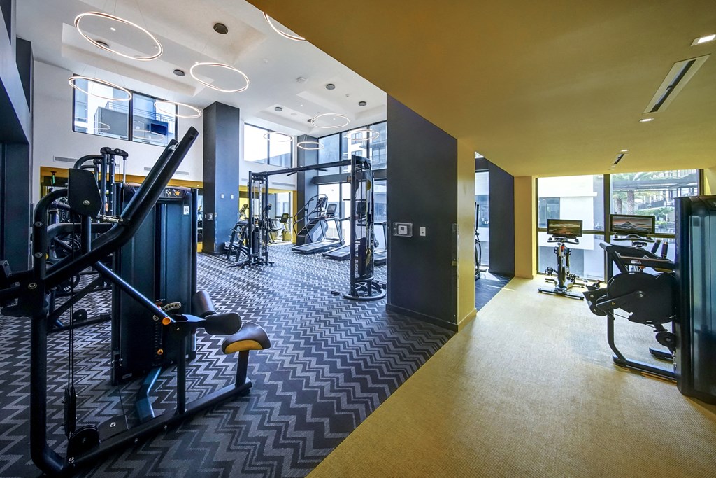 a workout room with weights and other exercise equipment in a building