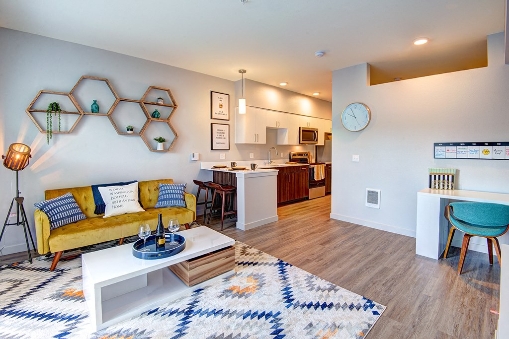 a living room with a yellow couch and a table