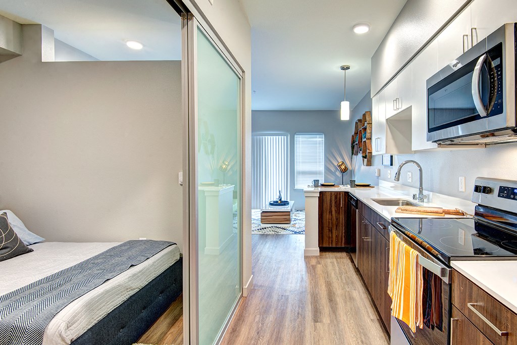 a bedroom and a kitchen in a small apartment