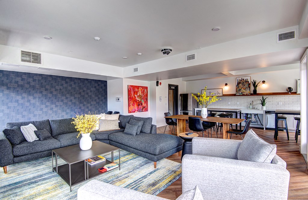 a living room with couches and chairs and a table