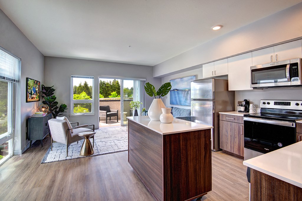 an open kitchen and living room with a view of a patio