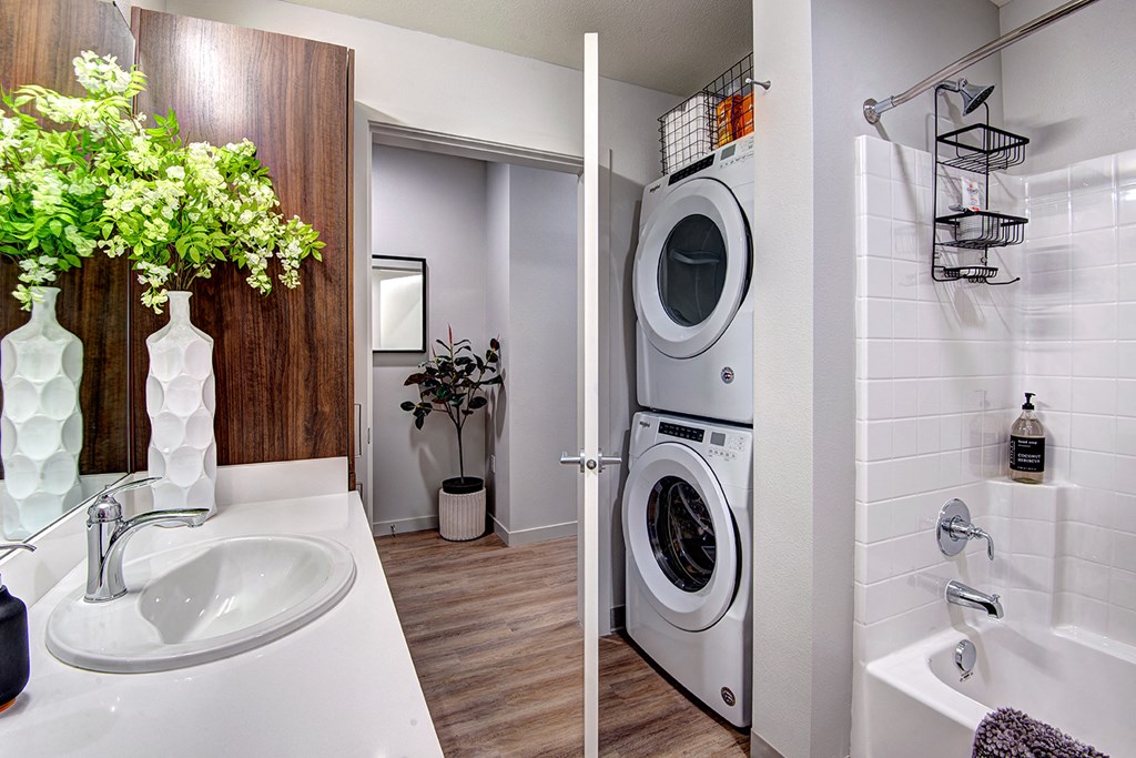 a bathroom with a washing machine and a dryer in it