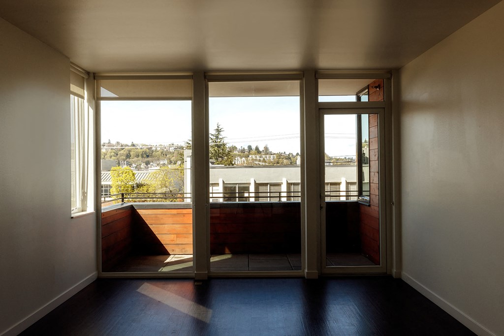 a living room with a view of a river and a balcony