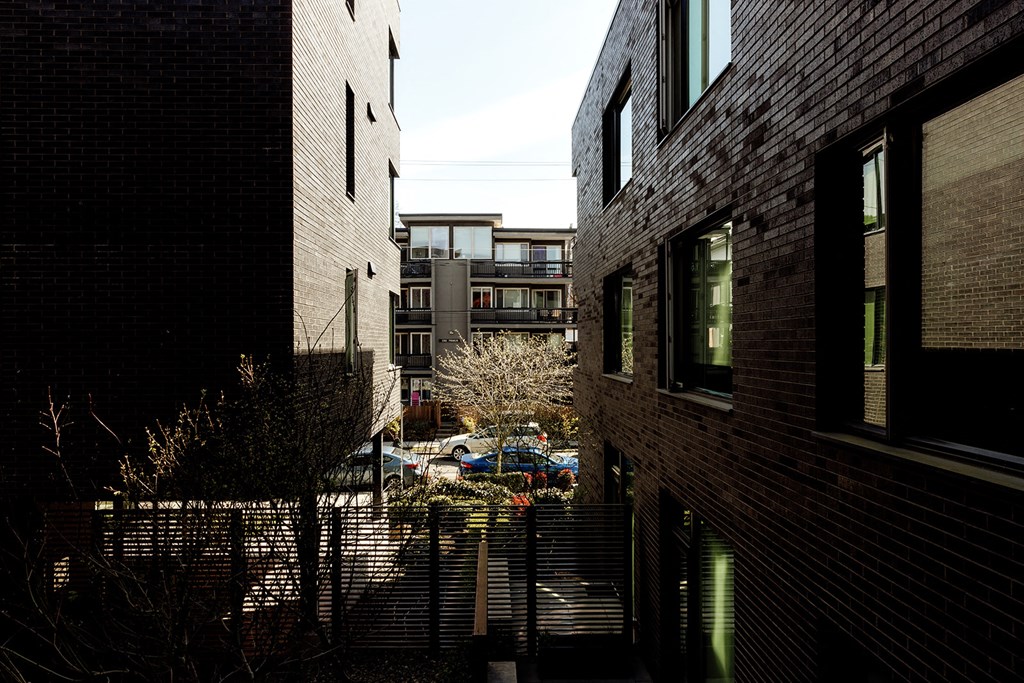 a view of a city street from an alley