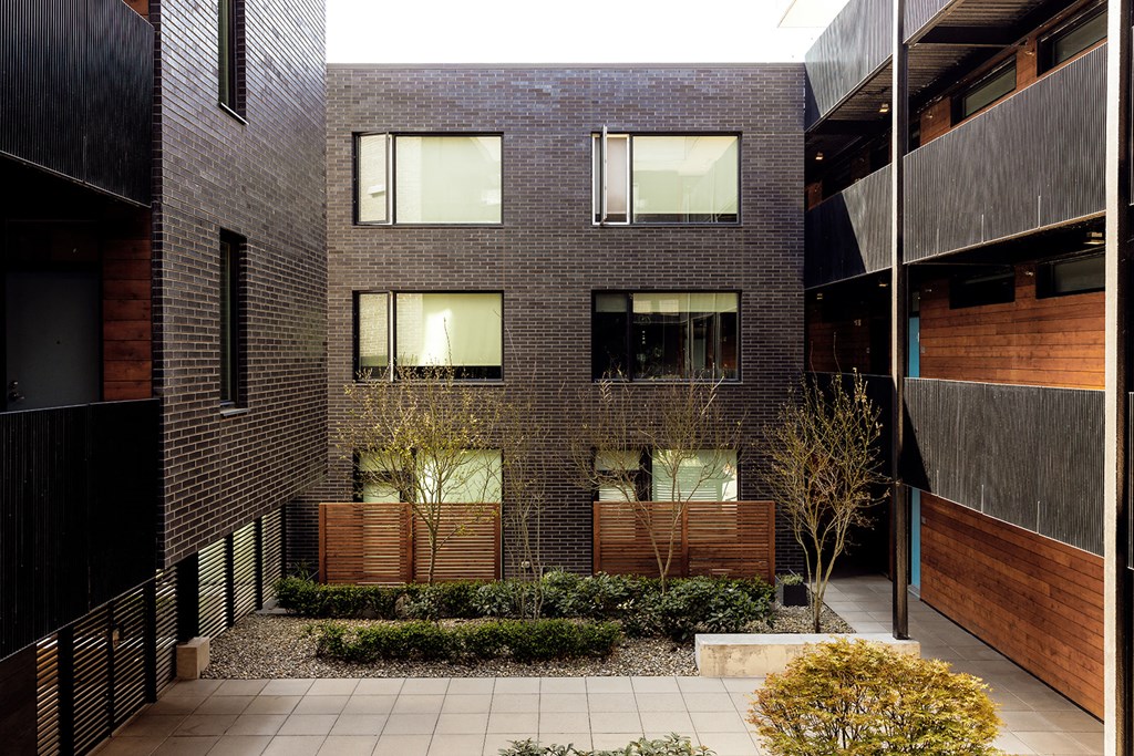 a brick building with a courtyard in front of it