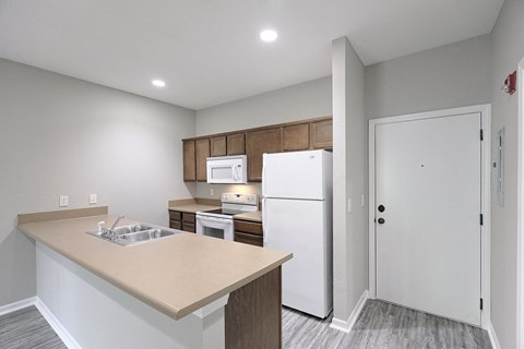 a kitchen with white appliances and a white refrigerator