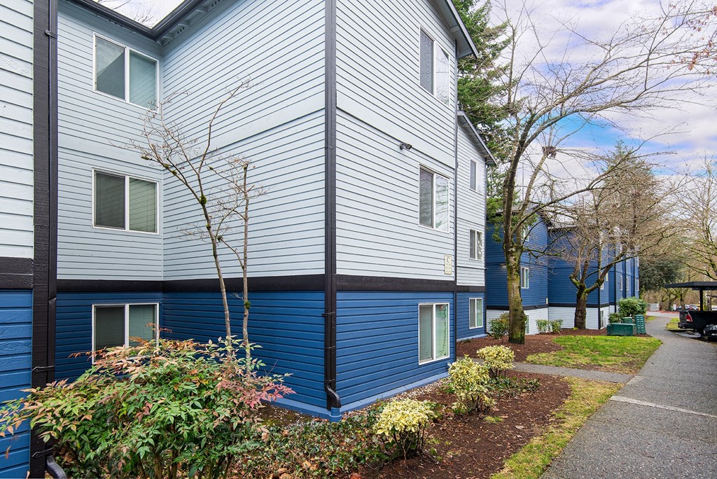 a blue and white building with a sidewalk in front of it