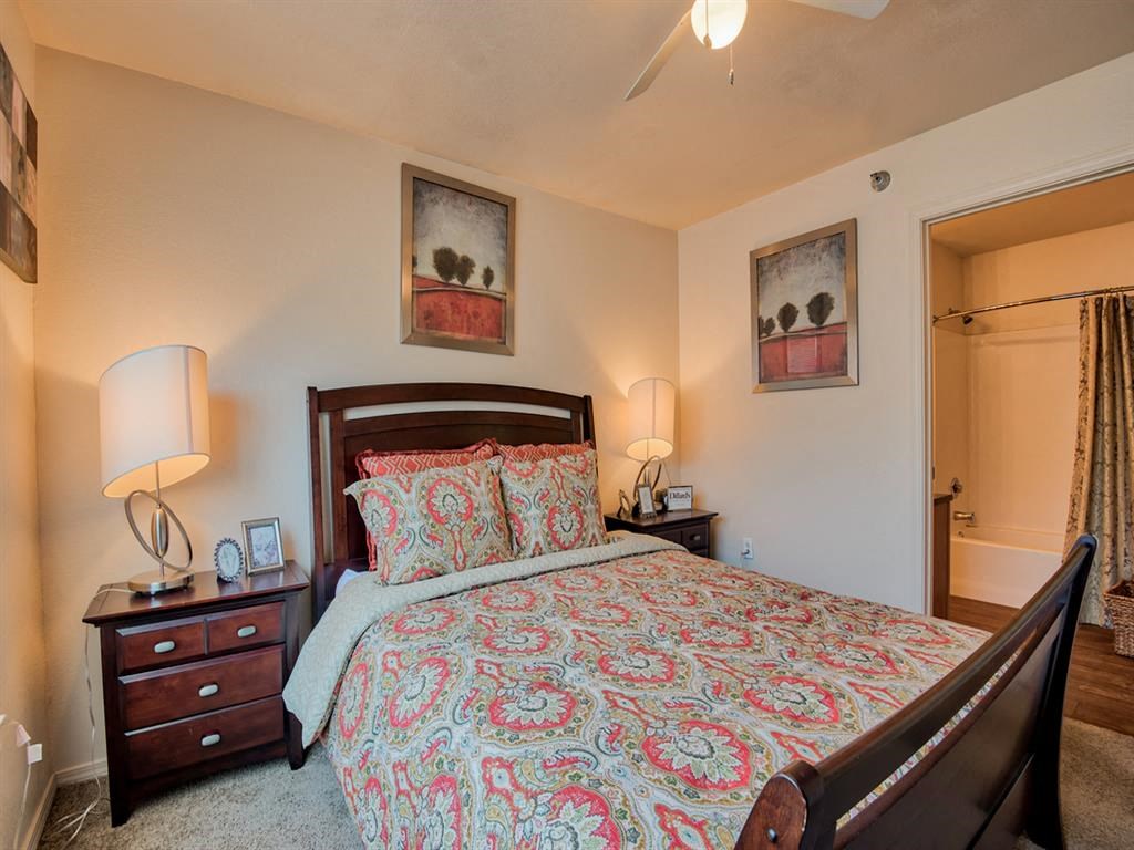 Bedroom with carpet floor, queen size bed, and ceiling fan