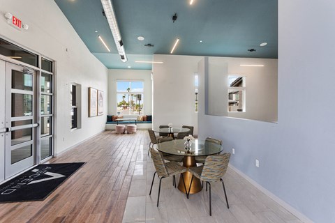 a dining room with a glass table and chairs