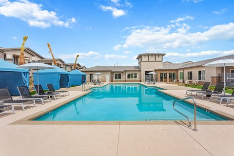 our apartments have a swimming pool with chairs and umbrellas