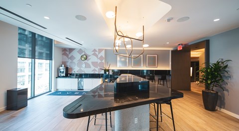 A modern dining room with a black table and chairs.