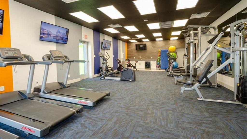 a gym with treadmills and other exercise equipment