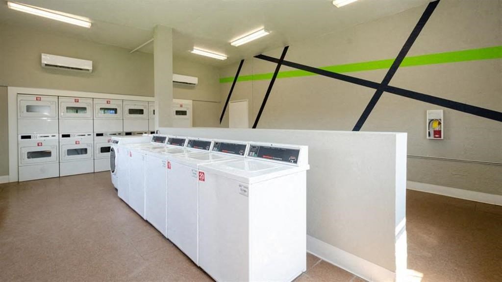 a row of washers and dryers in a room