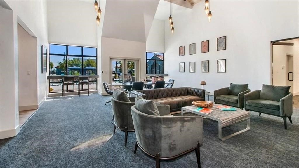 a living room filled with furniture and a large window