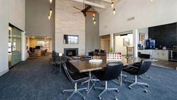 a large room with a table and chairs and a fireplace