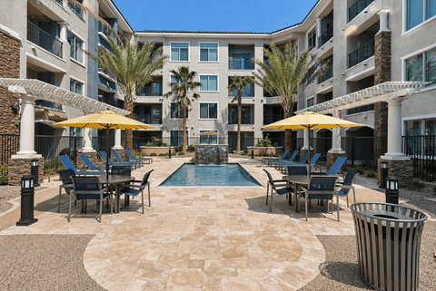 A large courtyard with a pool surrounded by apartment buildings.